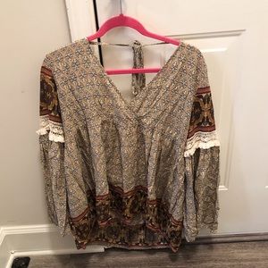 Small printed top. Tie in the back. Hardly worn.